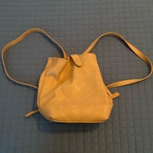 tan mini backpack with inside zippers and pockets